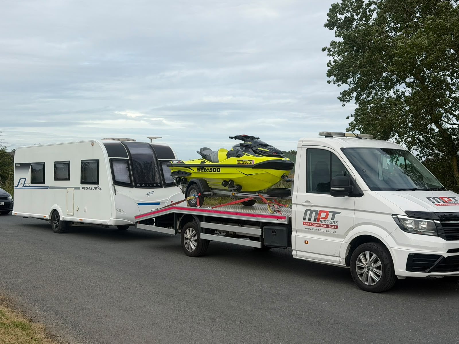 MPT Recovery transporting a caravan on a flatbed recovery truck